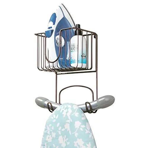 mDesign Wall Mount Metal Ironing Board Holder with Small Storage Basket - Holds Iron, Board, Spray Bottles, Starch, Fabric Refresher for Laundry Rooms - Bronze